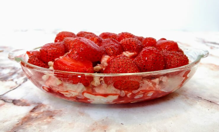 clear bowl filled with roasted strawberries and oatmeal