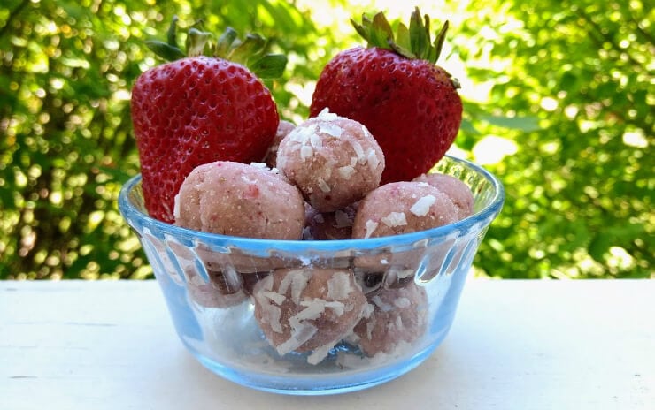 clear bowl filled with strawberries and shortcake energy bites