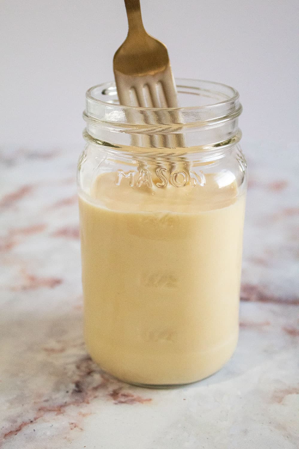 jar of keto condensed milk with fork in it