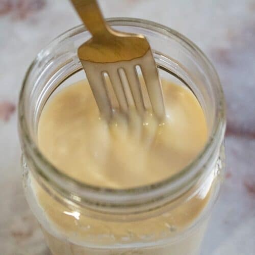 overhead view of fork inside jar full of keto sweetened condensed milk