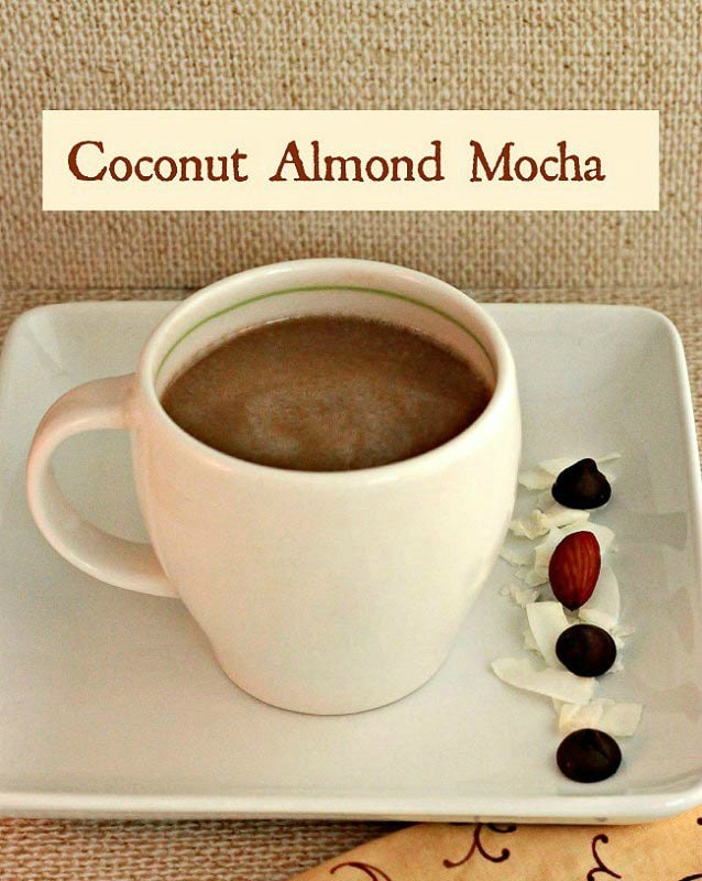 white coffee cup containing coffee flavored almond mocha next to almonds