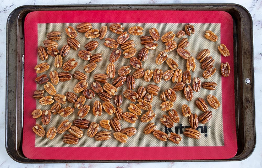 chocolate covered pecans not yet covered in chocolate on a baking tray