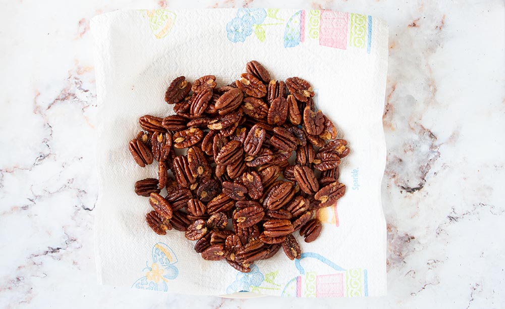 chocolate covered pecans toasted on a paper towel