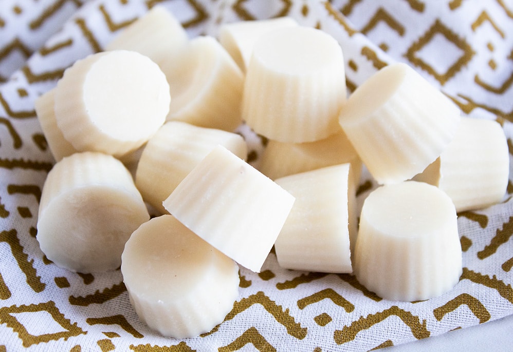 closeup of pina colada keto fat bombs on a gold and white towel