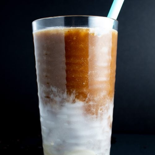 keto iced coffee closeup of glass with blue straw