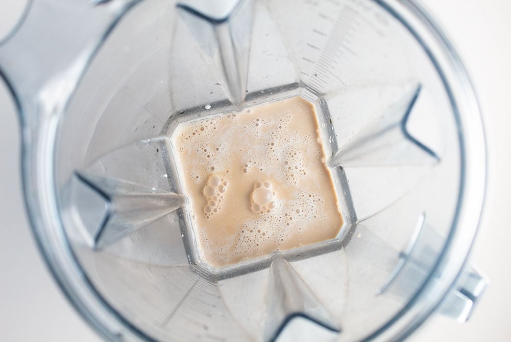 iced keto coffee liquid inside the bottom of a blender