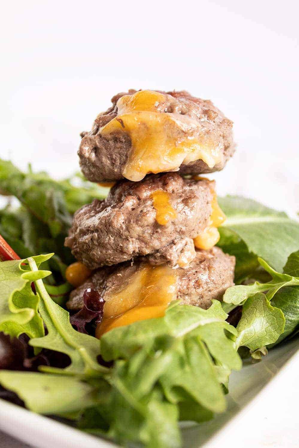 butter burgers stacked on bed of lettuce