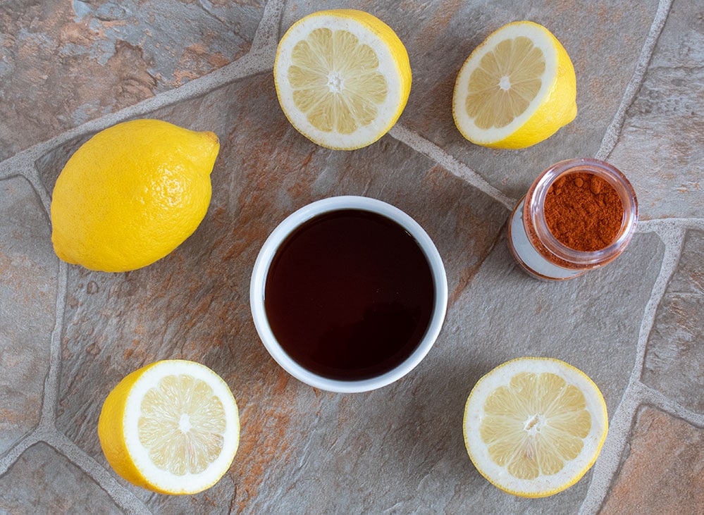 overhead view of keto detox water ingredients including sliced lemons and cayenne pepper