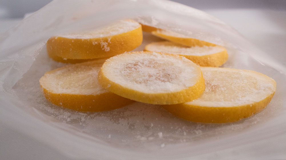 closeup of keto detox water sliced lemons frozen in a freezer bag