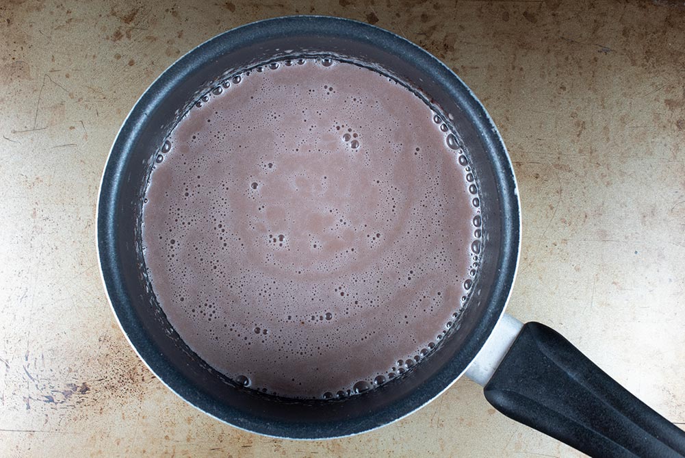 buttery keto hot chocolate in a sauce pan fully combined and heated