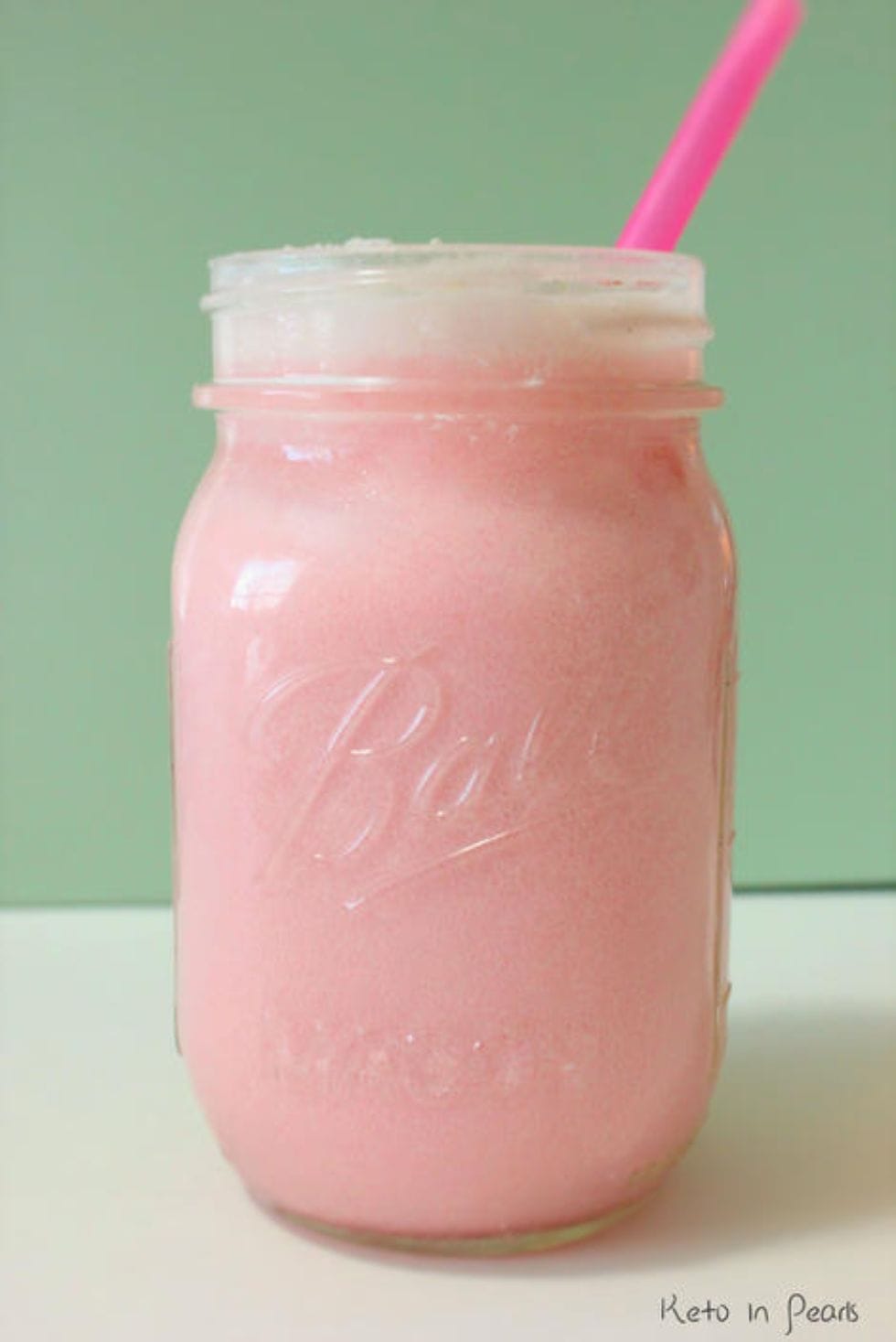 keto starbucks pink drink copycat in a mason jar with a pink straw