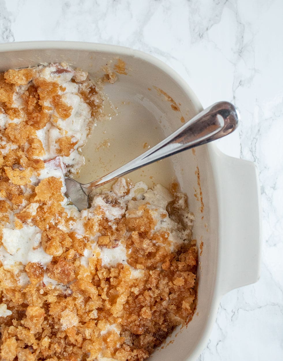 keto casserole dish with piece missing and butter on the bottom