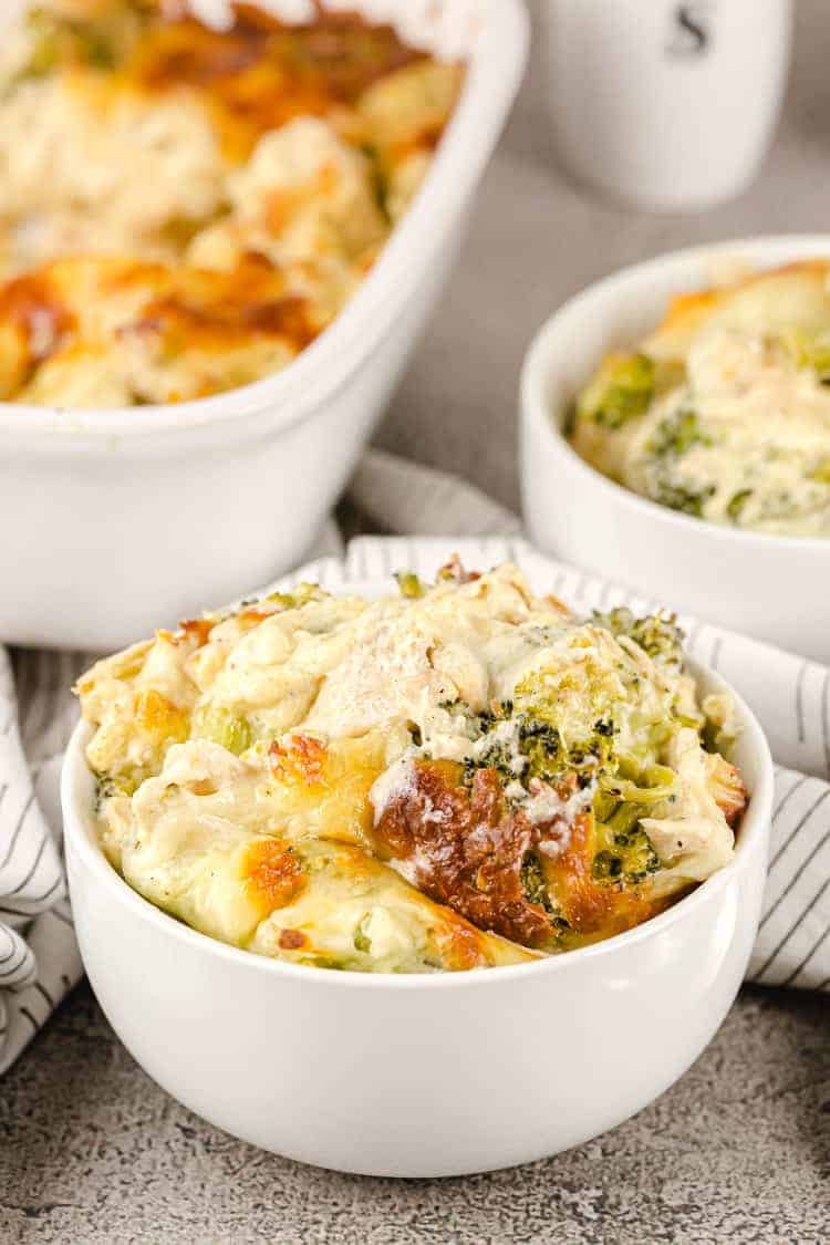 loseup of small white bowl containing a serving of keto chicken broccoli casserole