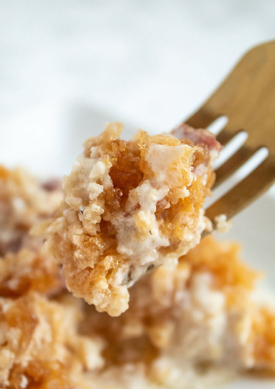 keto chicken casserole being held up by a gold fork