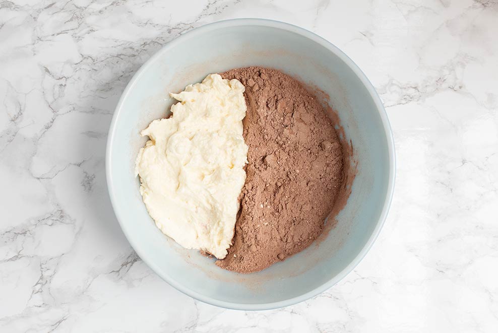 keto chocolate heaven ingredients sitting in a blue bowl with white inside