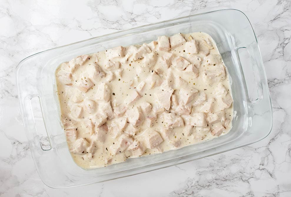 keto alfredo casserole overhead view of casserole dish with alfredo sauce on chicken