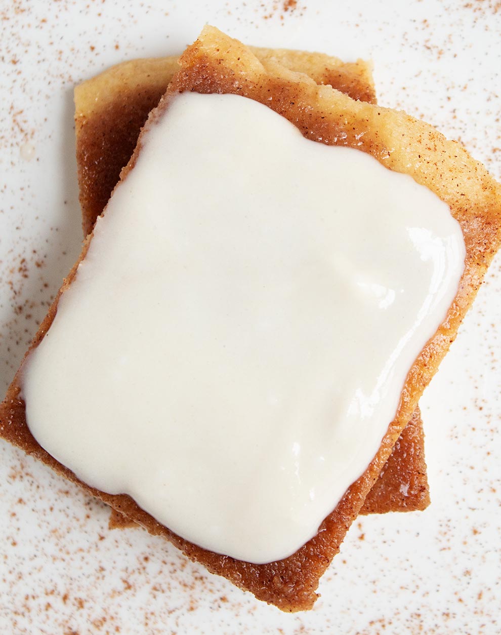 overhead view of keto cinnamon roll with thick white icing on top