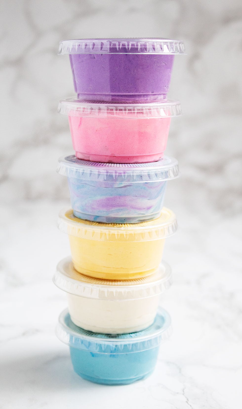 stack of keto frosting shots in individual containers with purple on the top