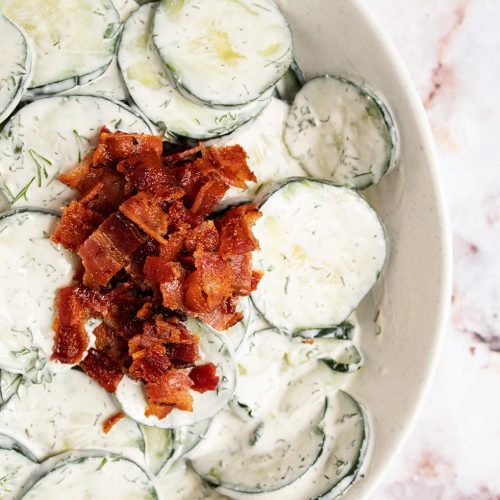 overhead view of keto cucumber salad with crumbled bacon on top