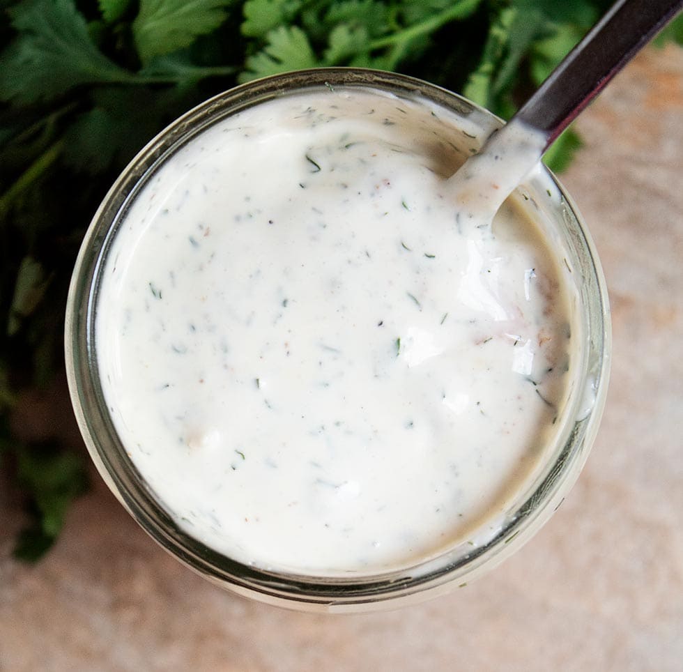 overhead view of creamy keto ranch dressing in a glass jar