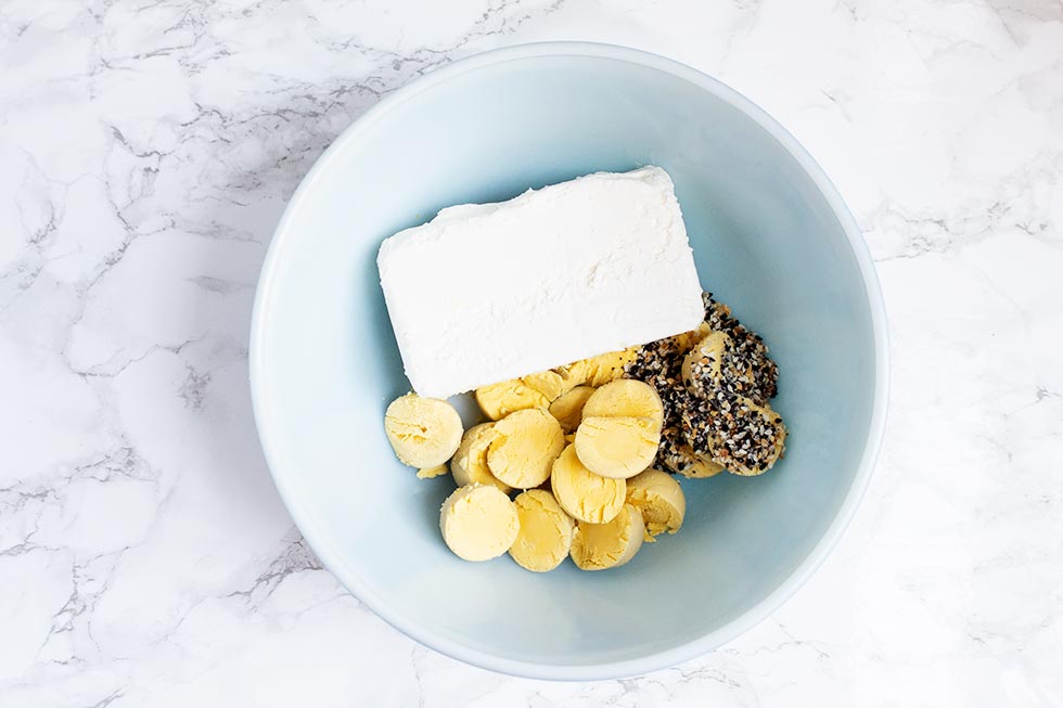 blue bowl containing ingredients used in keto deviled eggs