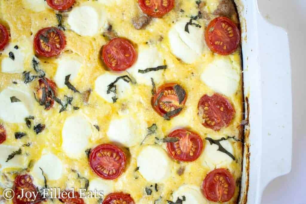 closeup of casserole dish containing tomatoes and cheese