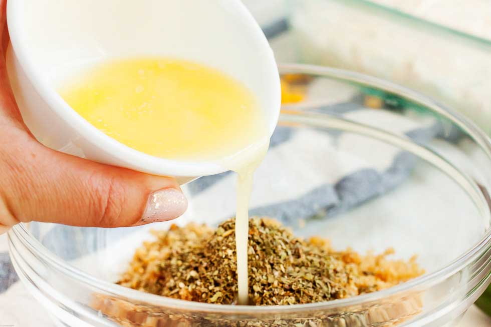 melted butter being poured into pork rinds and seasonings