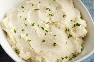 closeup of keto mashed cauliflower with dried parsley on top