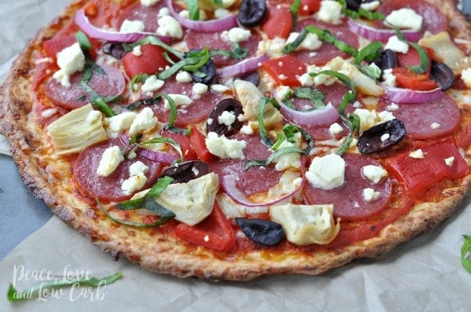 full pizza with salami basil feta cheese olives and artichokes