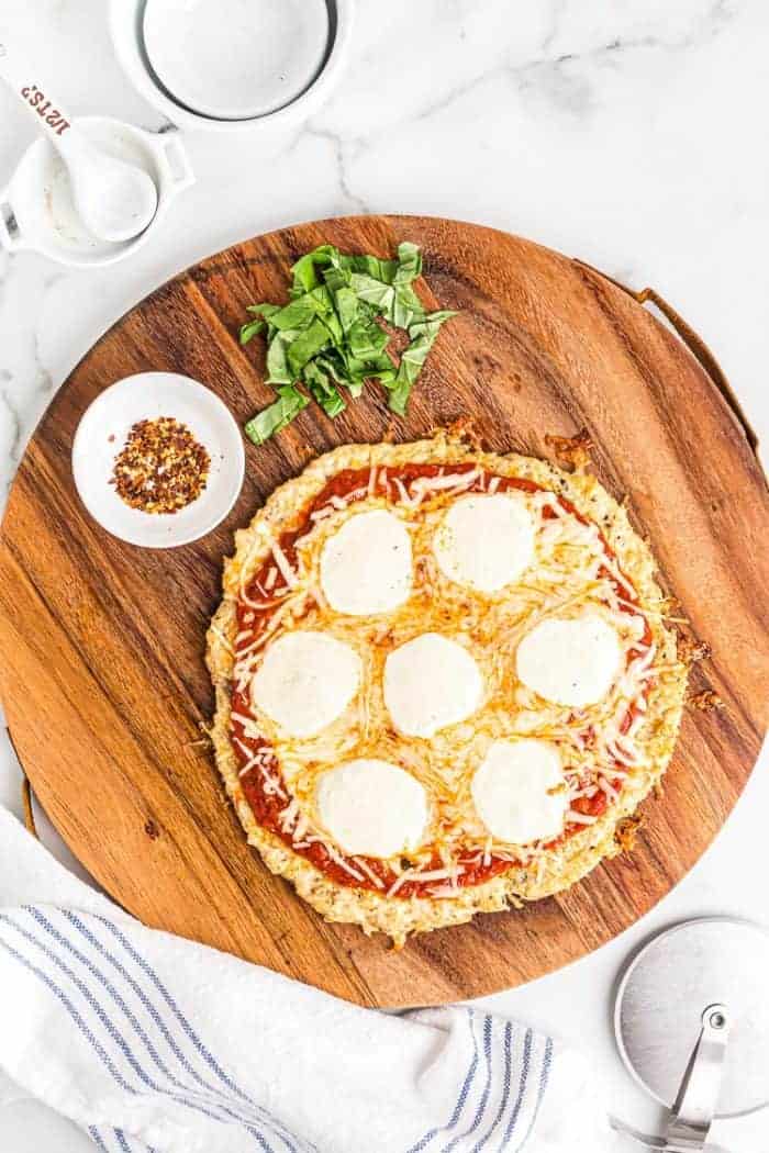overhead view of keto chicken pizza crust on a pizza platter