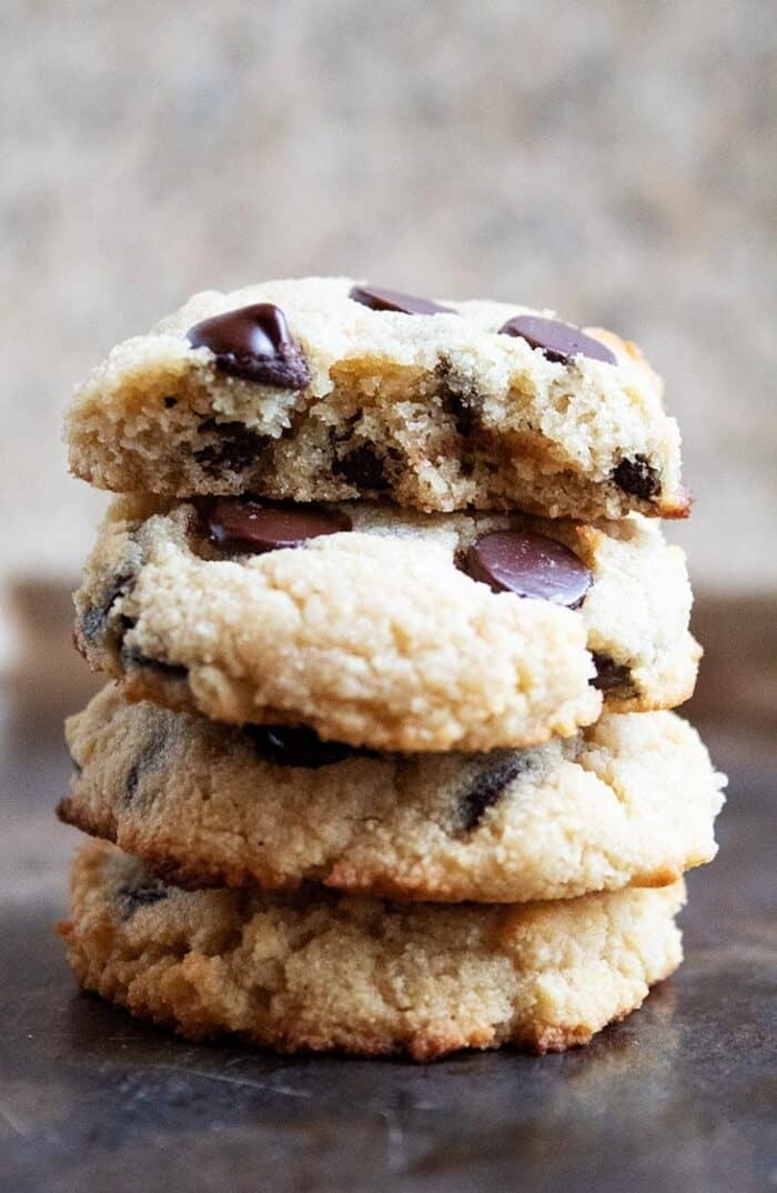 stack of three keto chocolate chip cookies on a baking sheet