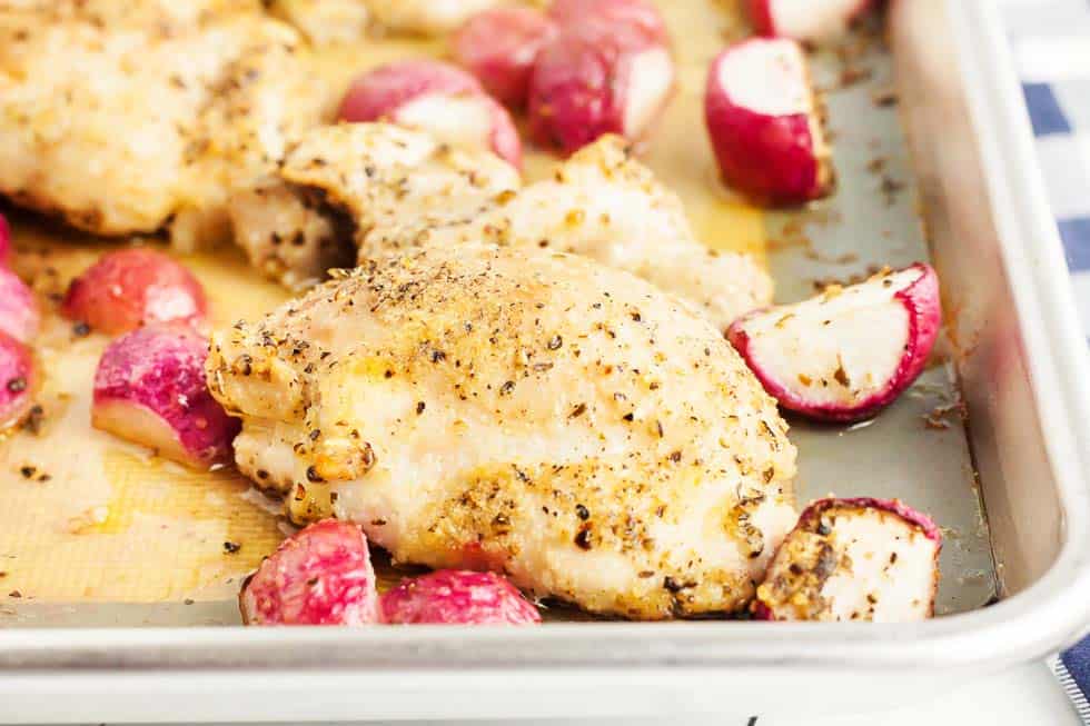 sheet pan chicken thighs with radishes on sheet pan after cooking