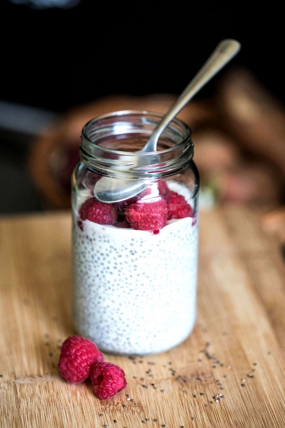 keto breakfast no eggs in a mason jar with raspberries and a spoon on top