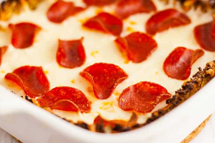 low carb crustless pizza casserole in a baking dish with pepperoni and cheese