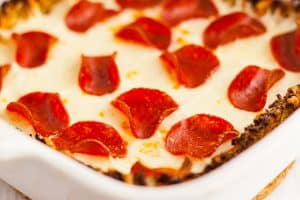 low carb crustless pizza in a baking dish with pepperoni and cheese
