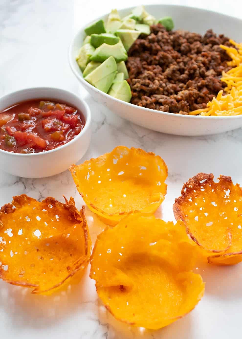 taco cups snacks with taco meat and salsa in bowl as no carb snacks