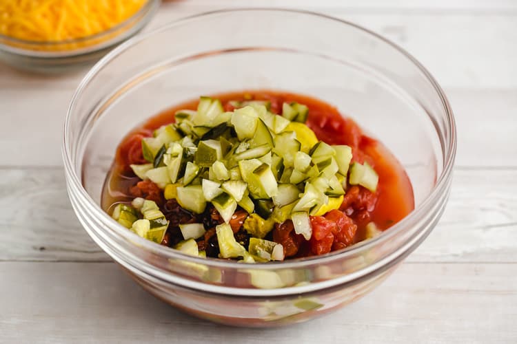 tomato pickles and cheese in a bowl