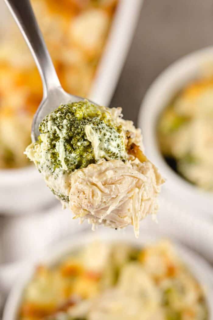 closeup of a spoon containing a spoonful of keto chicken broccoli casserole