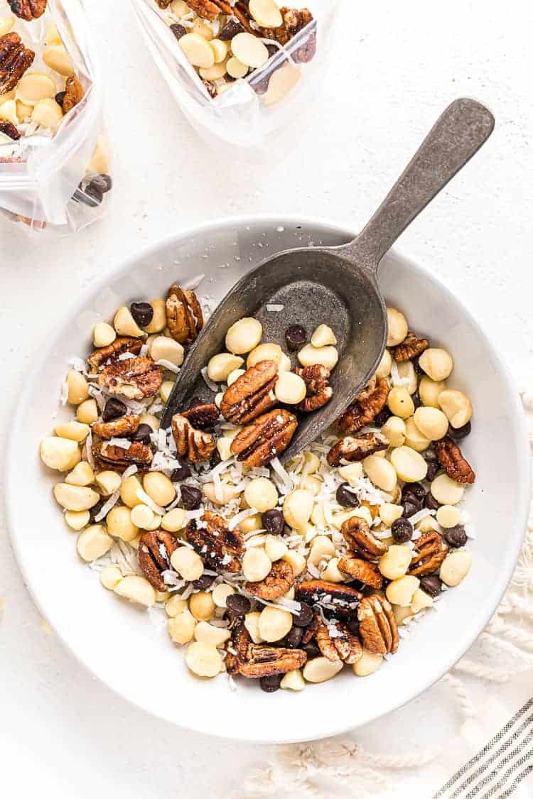 overhead view of keto trail mix in a white bowl with a spoon