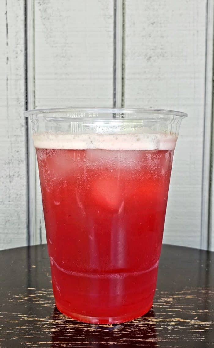 keto starbucks refresher in a clear glass in front of grey shiplap