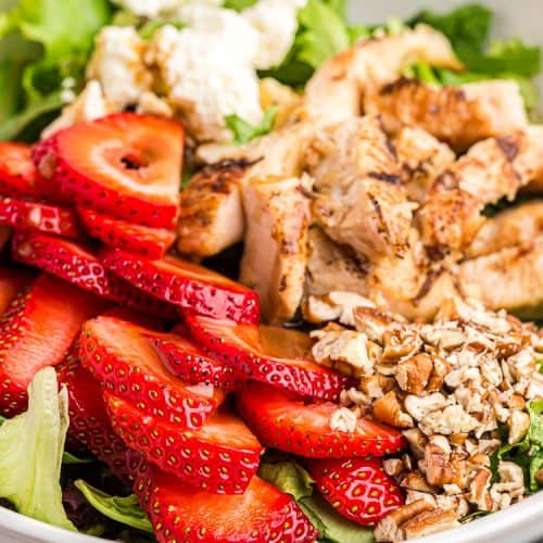 side view closeup of keto strawberry chicken salad with feta cheese and pecans on top