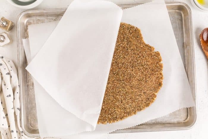 dough between parchment paper for keto cracker recipe