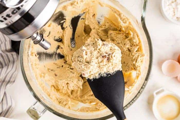 closeup of keto pecan snowball cookies batter on a black spoon