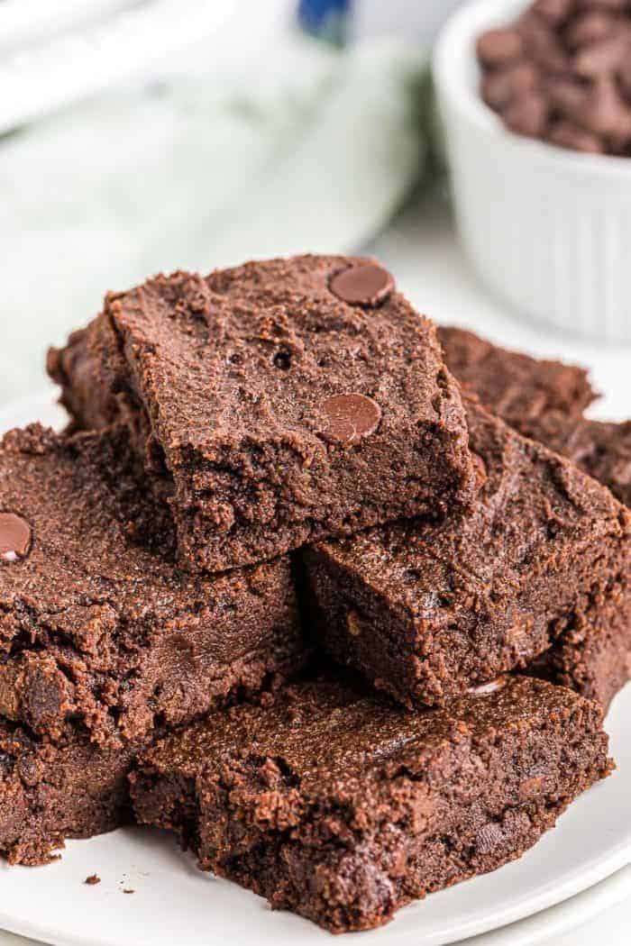 closeup of stacked keto chocolate cookies on a white plate