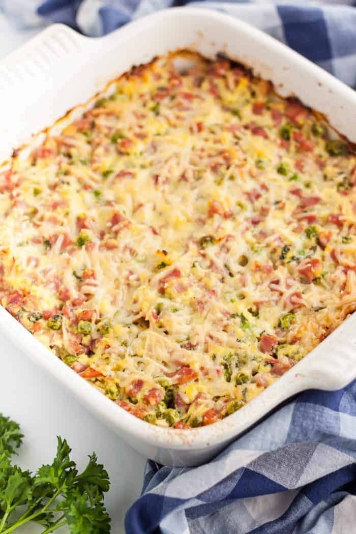 keto ham casserole in a white casserole dish next to a towel