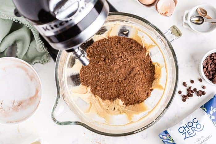 overhead view of mixer with cocoa powder on top making low carb cookie casserole