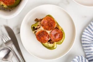 overhead view of single keto stuffed bell pepper on a white plate