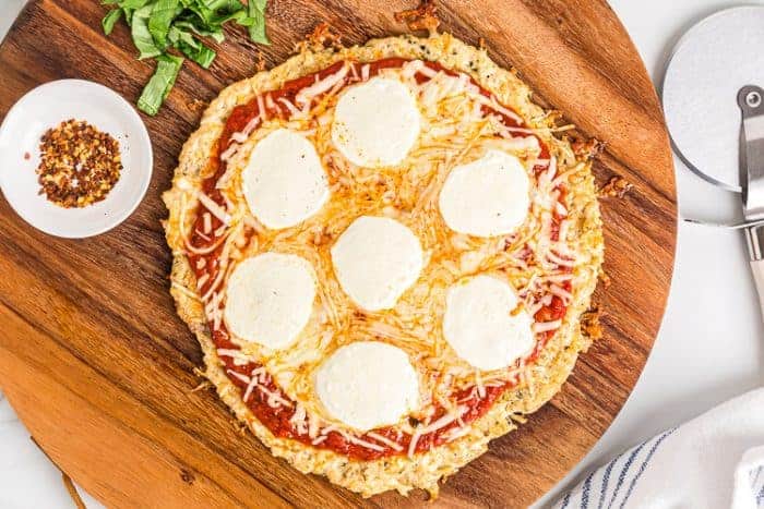 overhead view of cooked keto chicken crust pizza with melted cheese