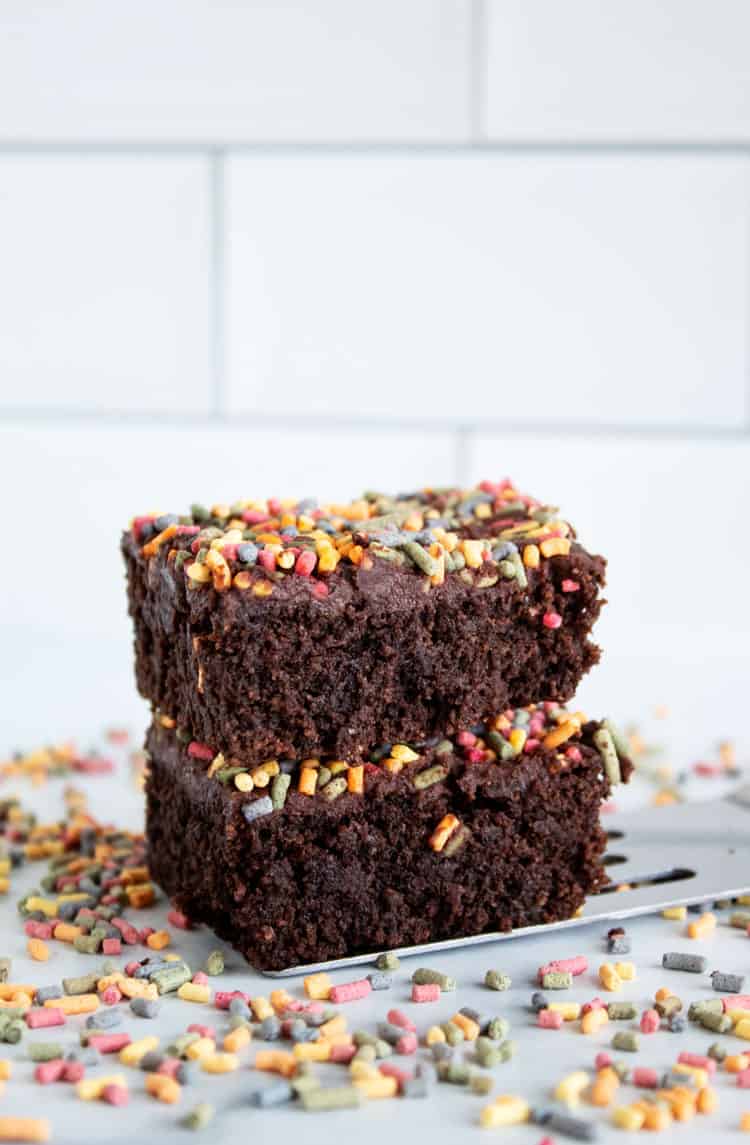 stack of two keto brownies surrounded by sprinkles