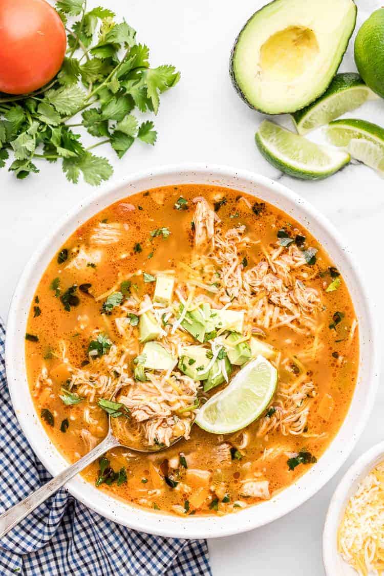 overhead view of keto chicken enchilada soup with a lime wedge on top